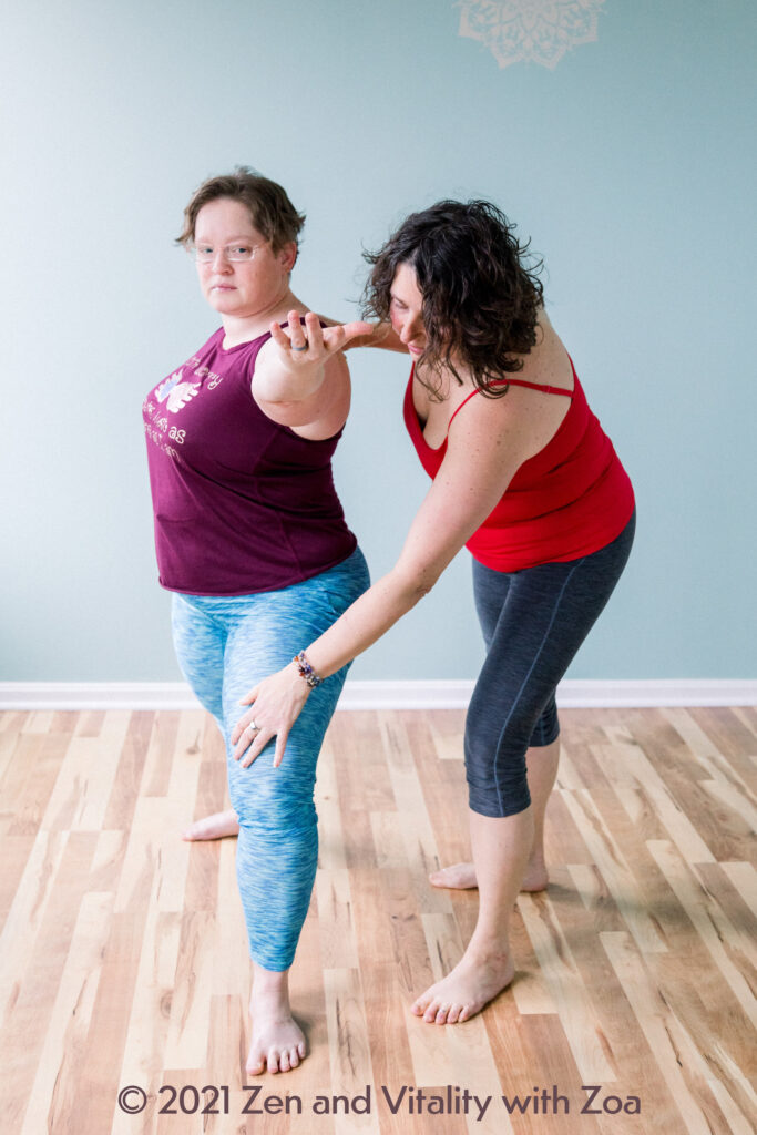 Zoa teaching the Warrior 2 yoga asana and correcting knee alignment