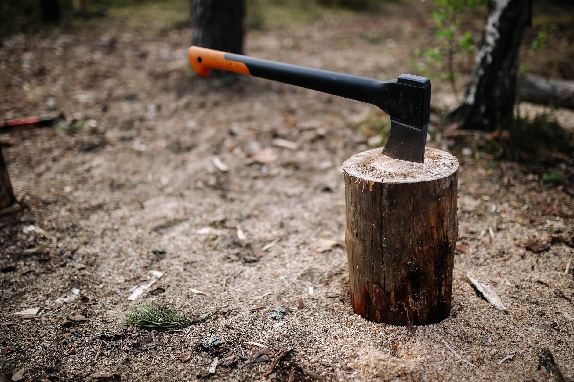 brown and black axe on brown wood log