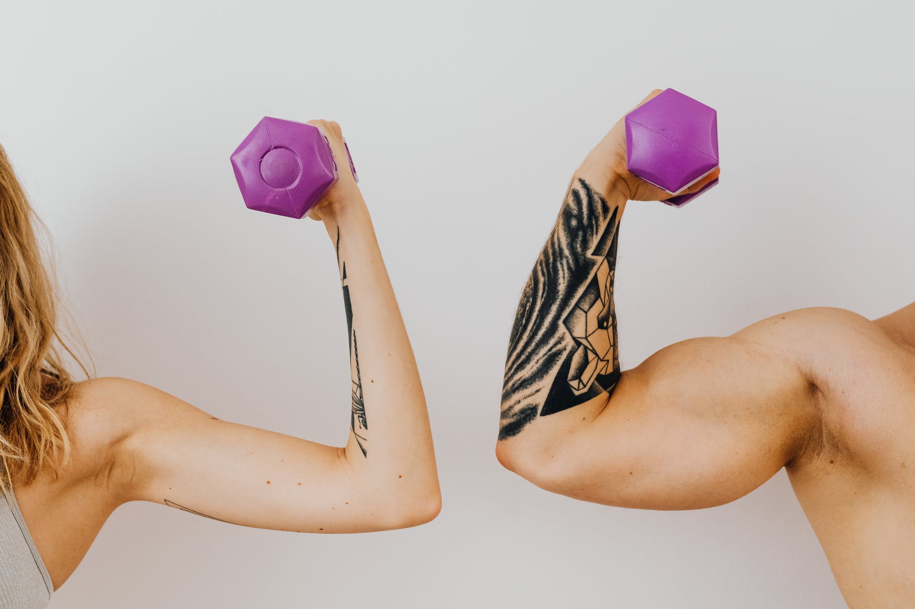 a woman and a man holding dumbbells