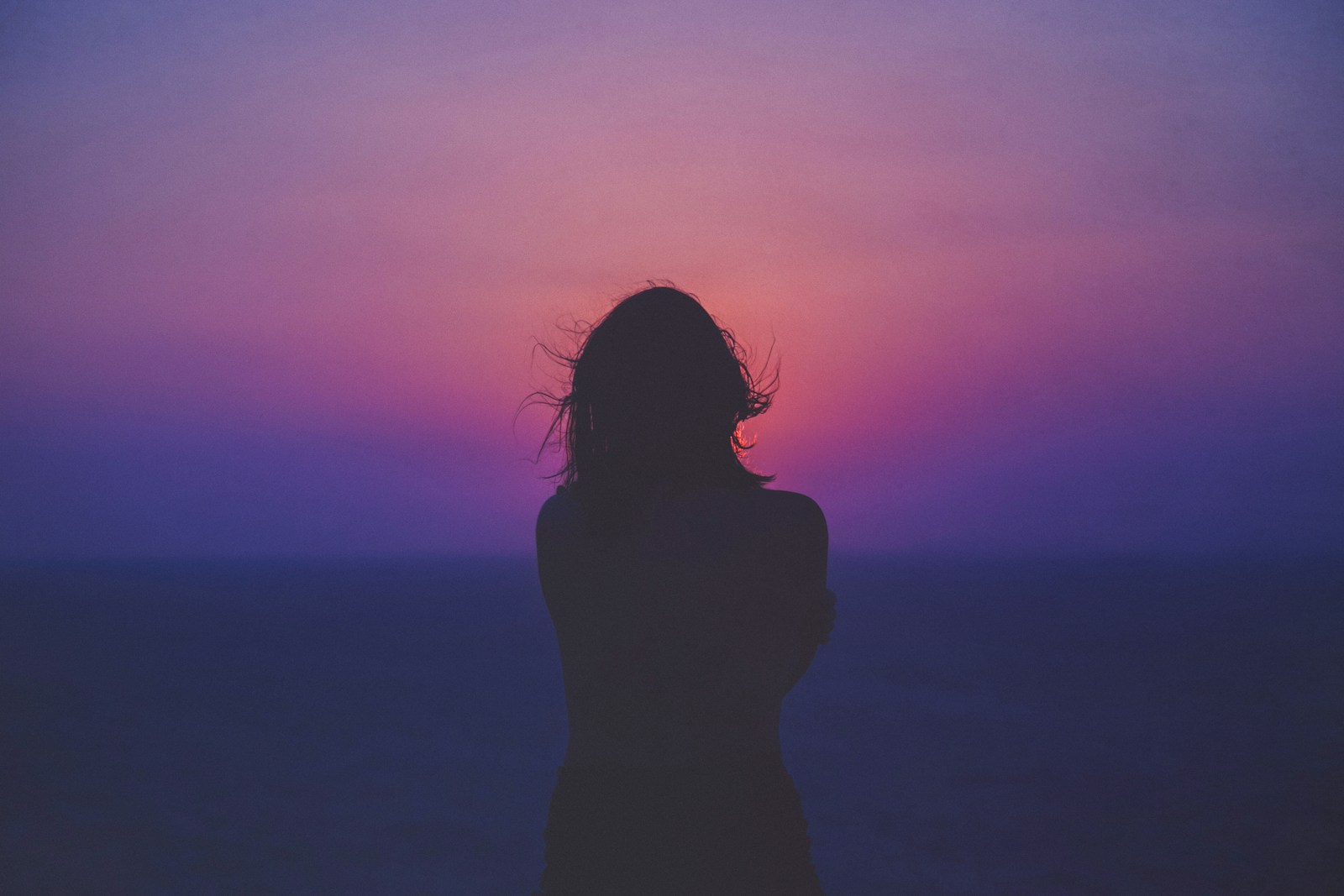 Photo by Sasha Freemind silhouette of a woman with pink and purple sky