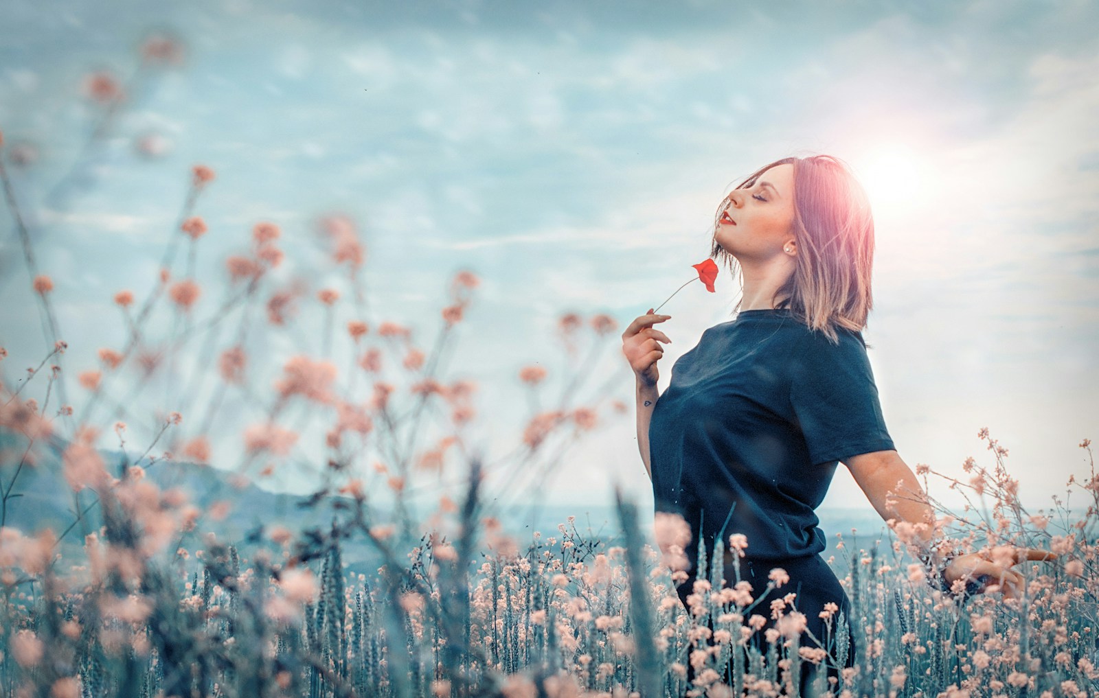 Photo by Erriko Boccia woman holding red flower